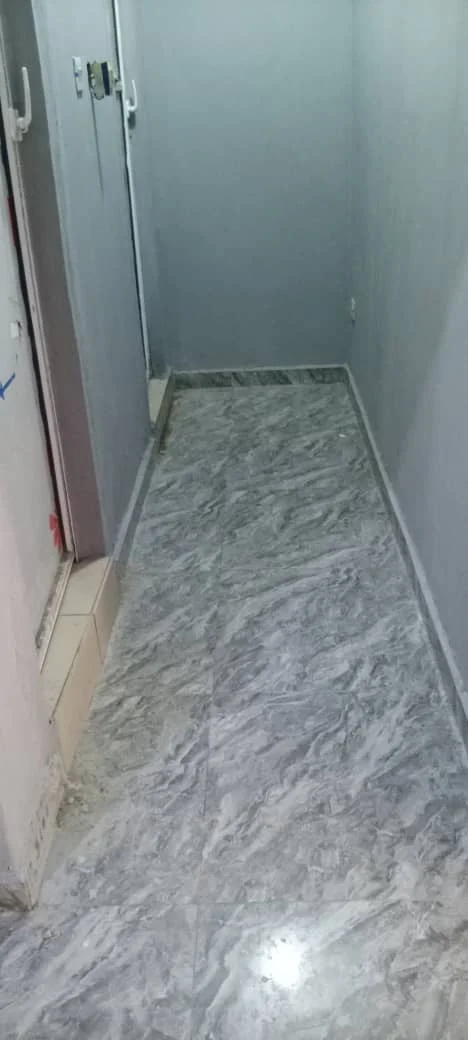 Company project photograph showing tiled flooring in an interior passage