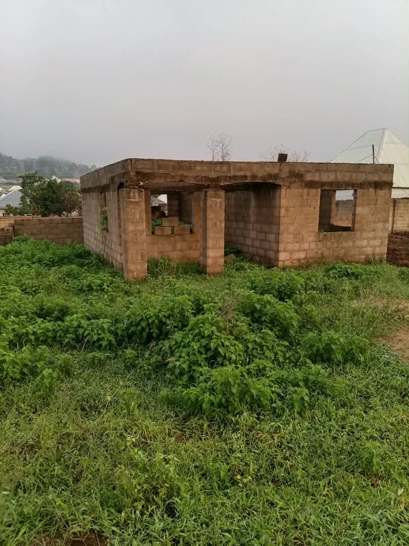Supplied site photograph showing an unfinished blockwork building with open door and window spaces