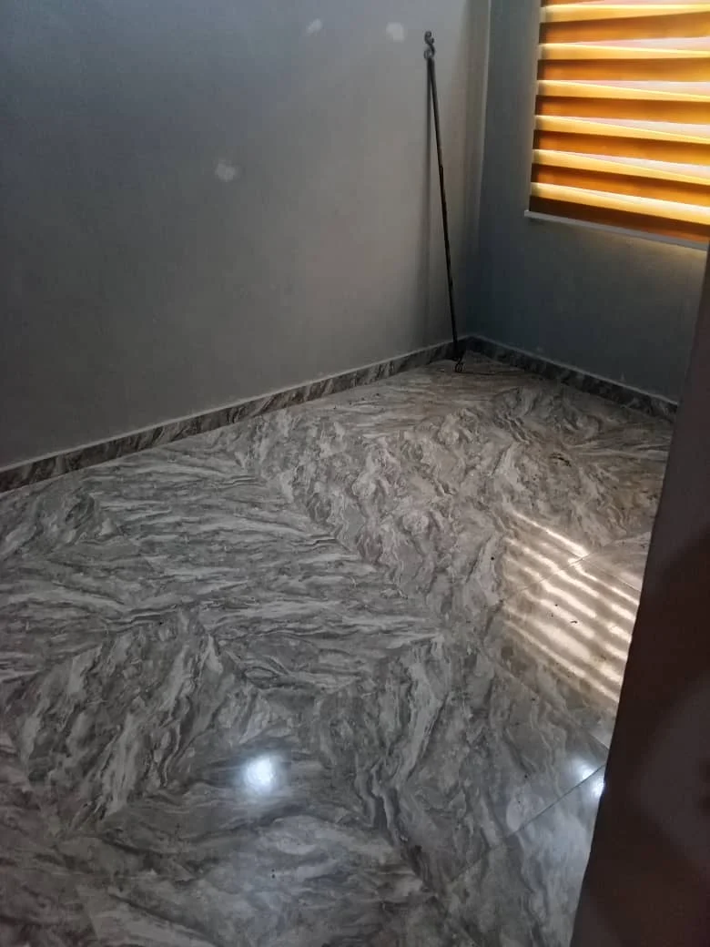 Company project photograph showing patterned floor tiles in an interior room